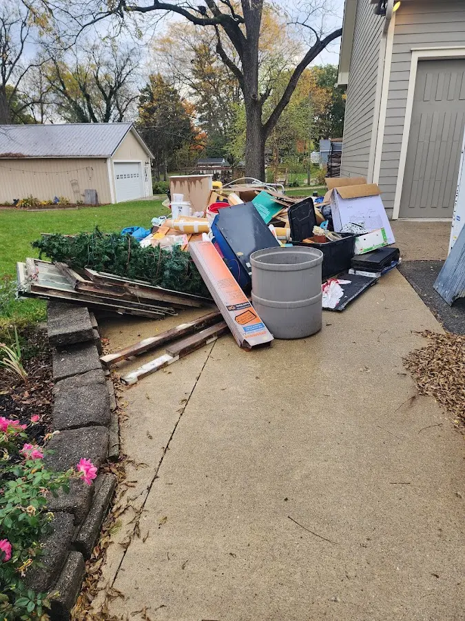 Dumpster being loaded with debris for Demolition Dumpster Rental in Llano